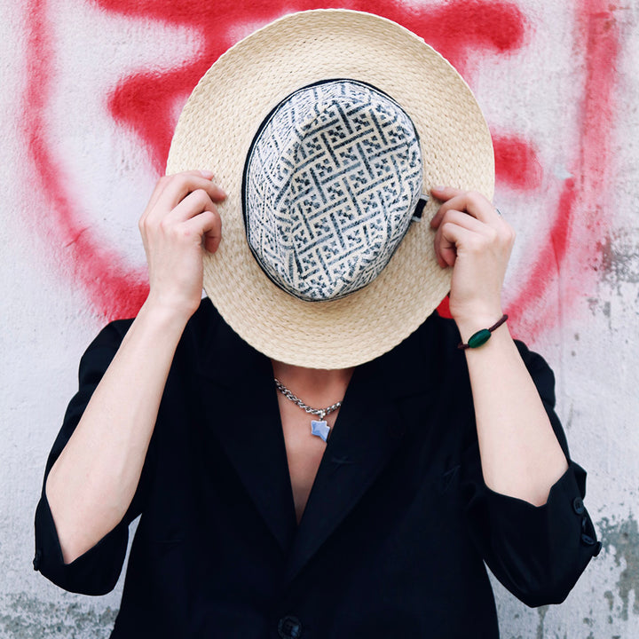 a woman with a hat covering her face