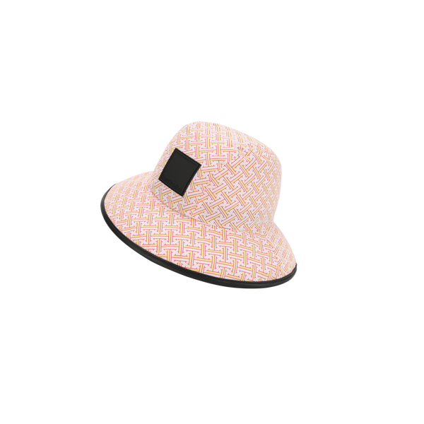 a pink and white hat with a black square on it