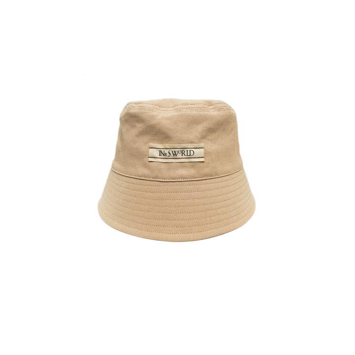 a tan hat with a bar logo on it